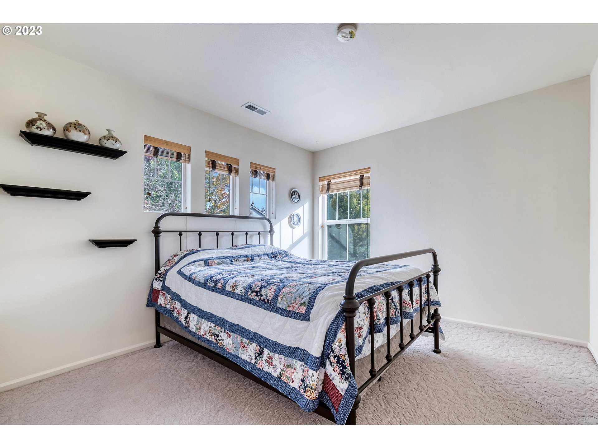 5588 Wales Drive Eugene, OR 97402 - Photo 29 of 41 a bed sitting in a bedroom next to a window with a baby crib