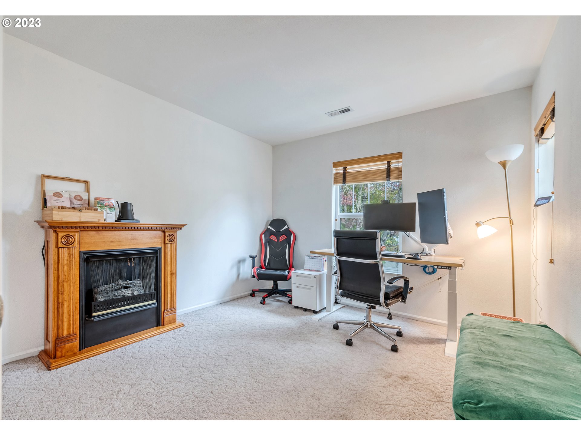 5588 Wales Drive Eugene, OR 97402 - Photo 30 of 41 a living room with furniture a flat screen tv and a fireplace