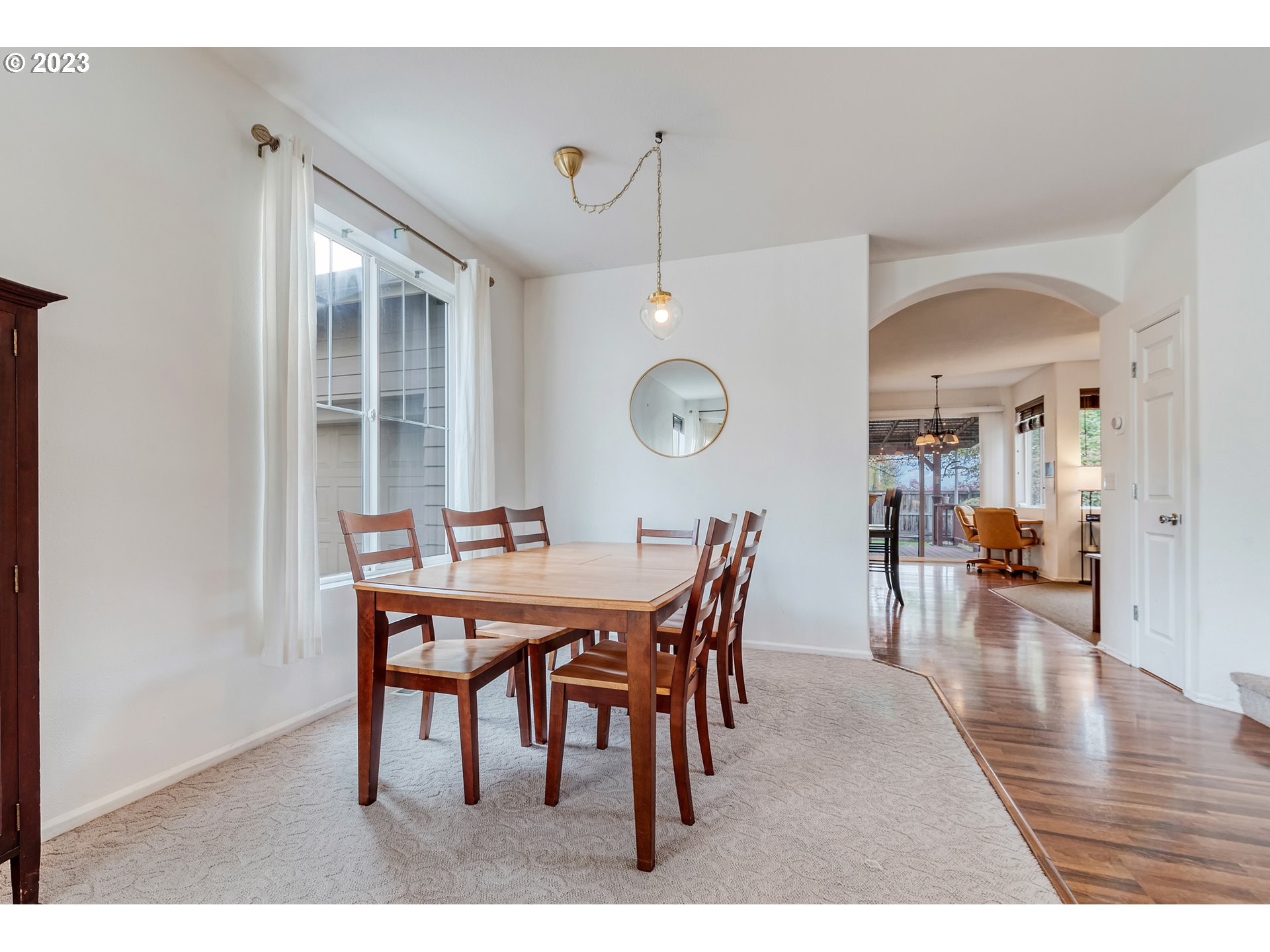5588 Wales Drive Eugene, OR 97402 - Photo 7 of 41 a view of a dining room and livingroom with furniture wooden floor and a chandelier