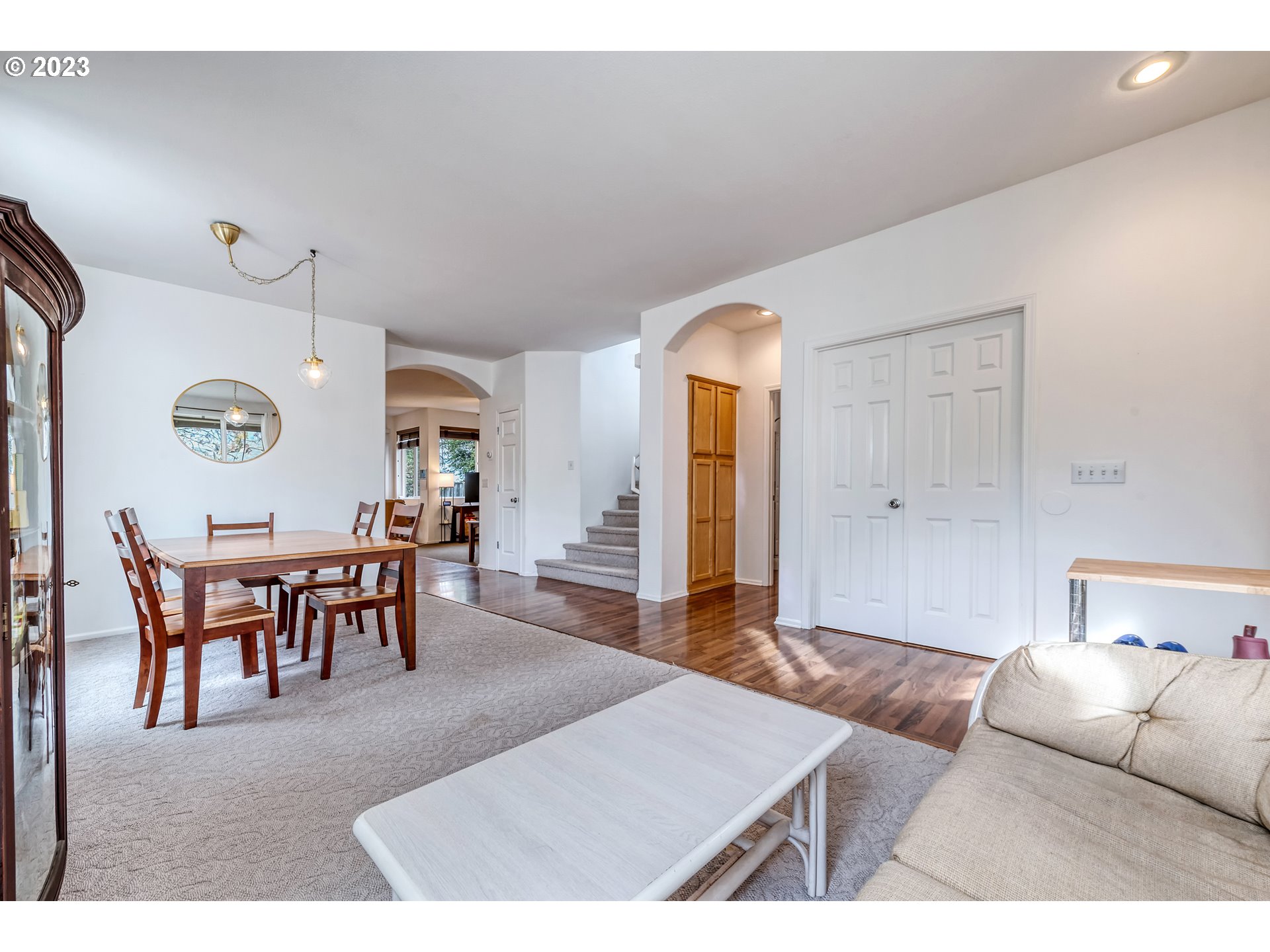 5588 Wales Drive Eugene, OR 97402 - Photo 8 of 41 a living room with furniture a dining table and a clock