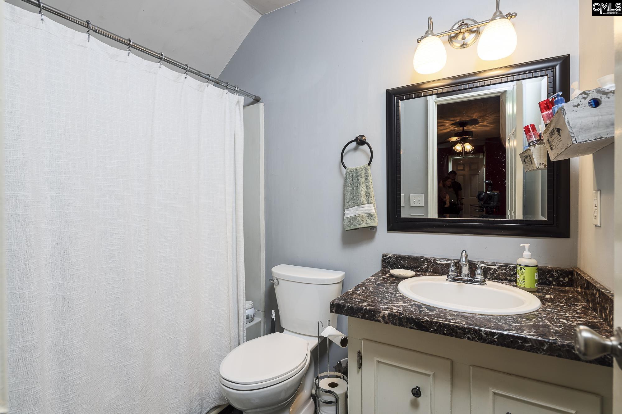 152 Thames Valley Court Irmo, SC 29063 - Photo 26 of 32 a bathroom with a granite countertop sink vanity mirror and toilet