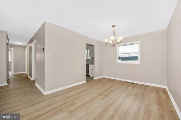 a view of a room with wooden floor and ceiling fan