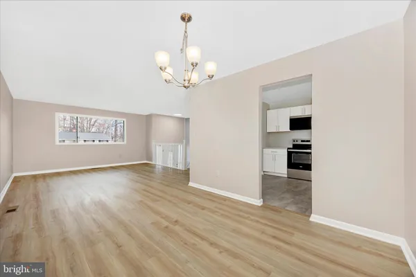 a kitchen with granite countertop white cabinets and stainless steel appliances