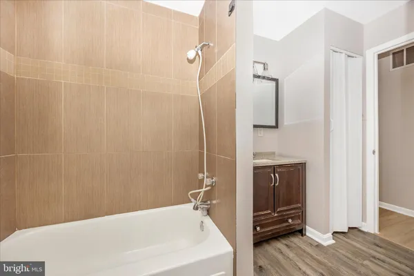 a view of an empty room with wooden floor