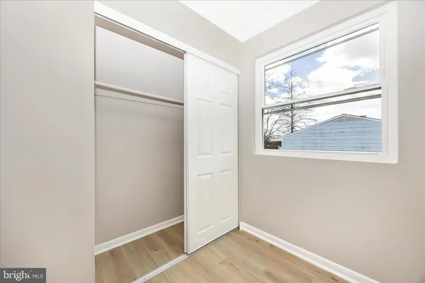 a bedroom with a bed and a potted plant