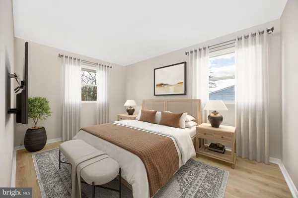 a room with a wooden floor and white wall