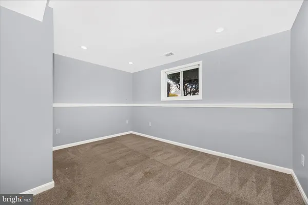 a view of a hallway with wooden floor and entryway