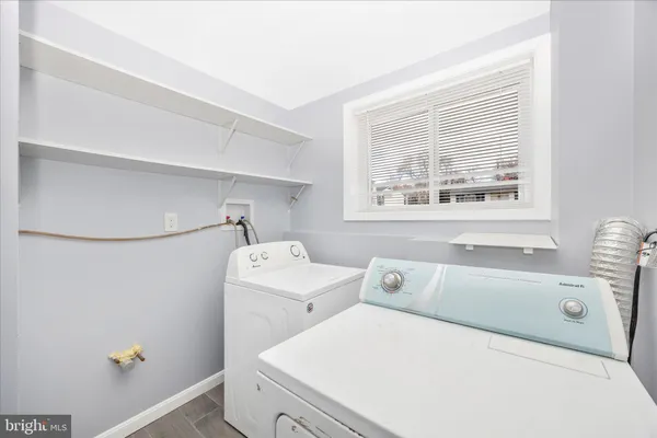 a view of a white house with large windows and a big yard