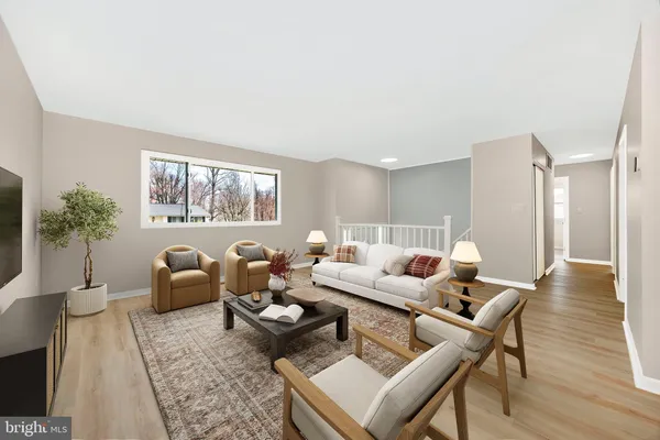 an empty room with wooden floor and a window