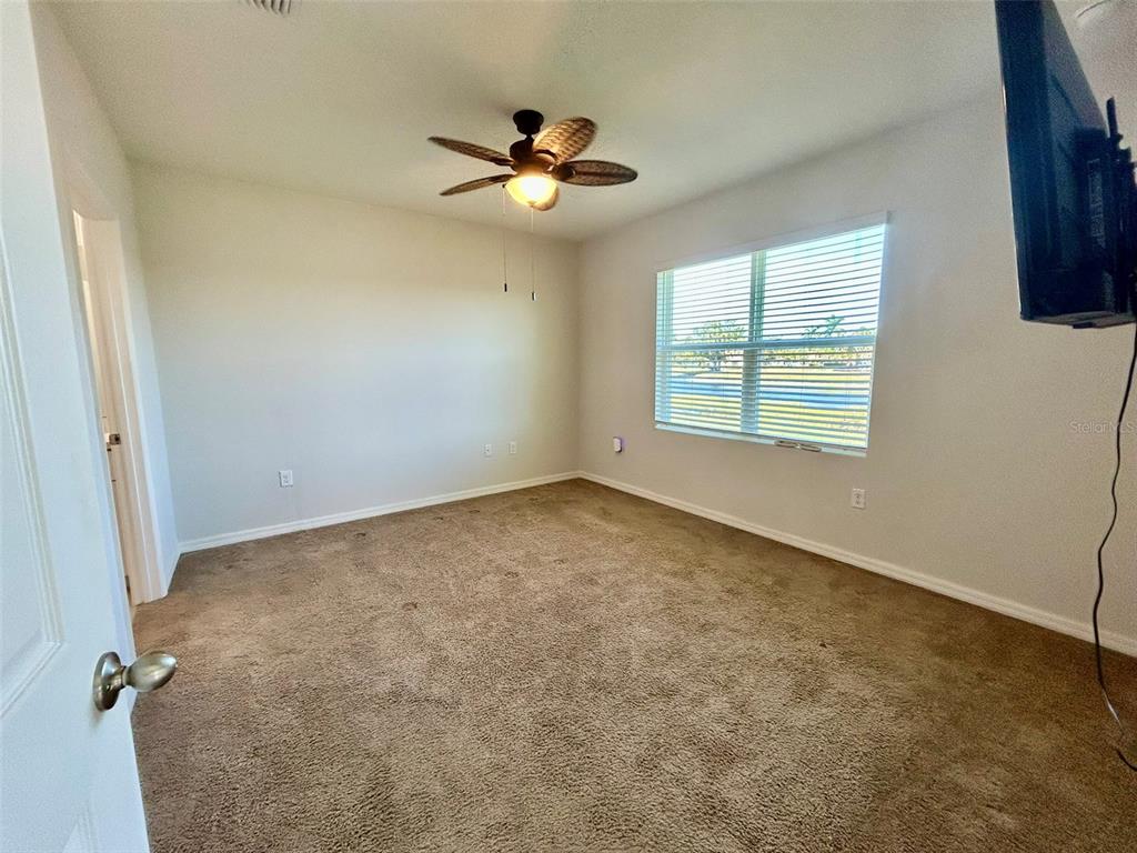 5270 Shell Mound Circle Punta Gorda, FL 33982 - Photo 11 of 23 an empty room with windows and fan