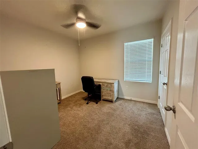 a room with pool table and ceiling fan