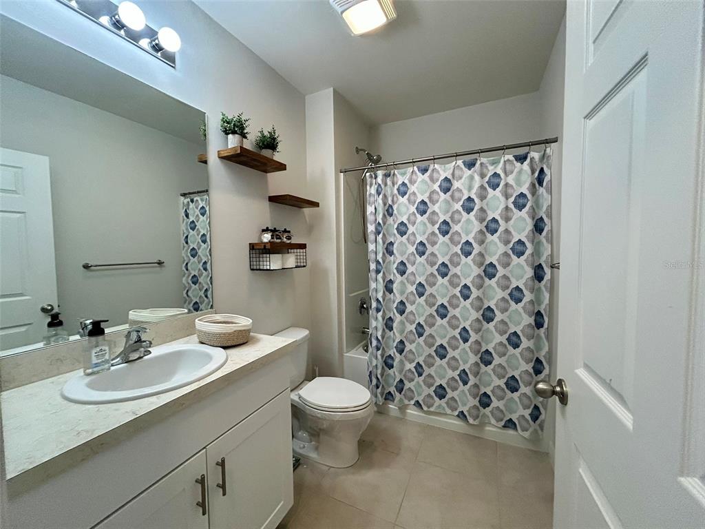 5270 Shell Mound Circle Punta Gorda, FL 33982 - Photo 17 of 23 a bathroom with a sink a toilet a shower and a mirror