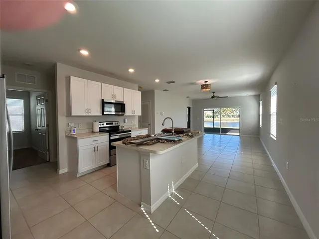 a kitchen with a sink cabinets and stainless steel appliances
