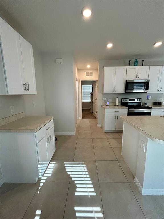 5270 Shell Mound Circle Punta Gorda, FL 33982 - Photo 5 of 23 a kitchen with kitchen island granite countertop a stove a sink and a refrigerator