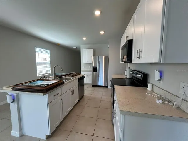 a kitchen with stainless steel appliances granite countertop a sink and a stove