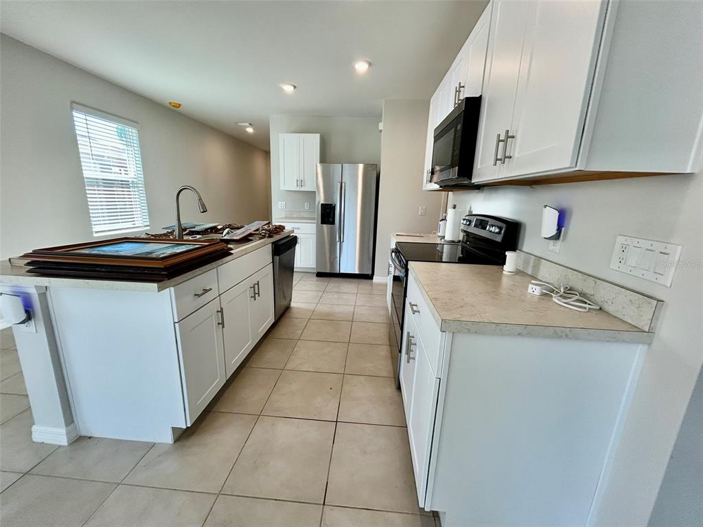 5270 Shell Mound Circle Punta Gorda, FL 33982 - Photo 6 of 23 a kitchen with stainless steel appliances granite countertop a stove a sink and a microwave