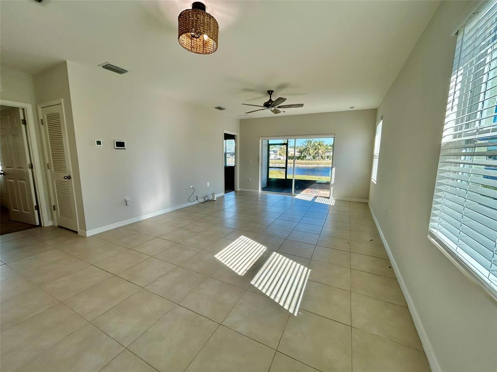 5270 Shell Mound Circle Punta Gorda, FL 33982 - Photo 8 of 23 wooden floor in an empty room with a window