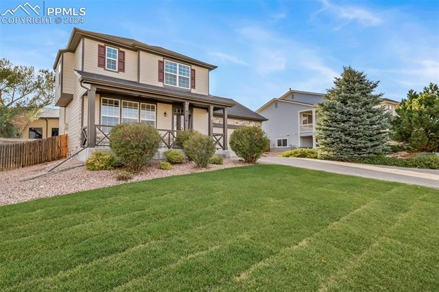 9356 Bethpage Road Peyton, CO 80831 - Photo 3 of 40 View of front property featuring a front lawn and a porch