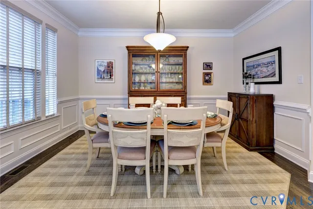 a dining room with furniture a chandelier and window