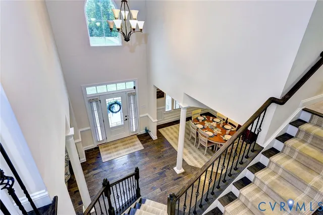 a living room with chairs and a wooden floor