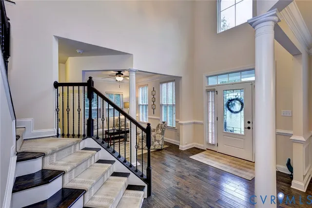 a view of an entryway with wooden floor and stairs