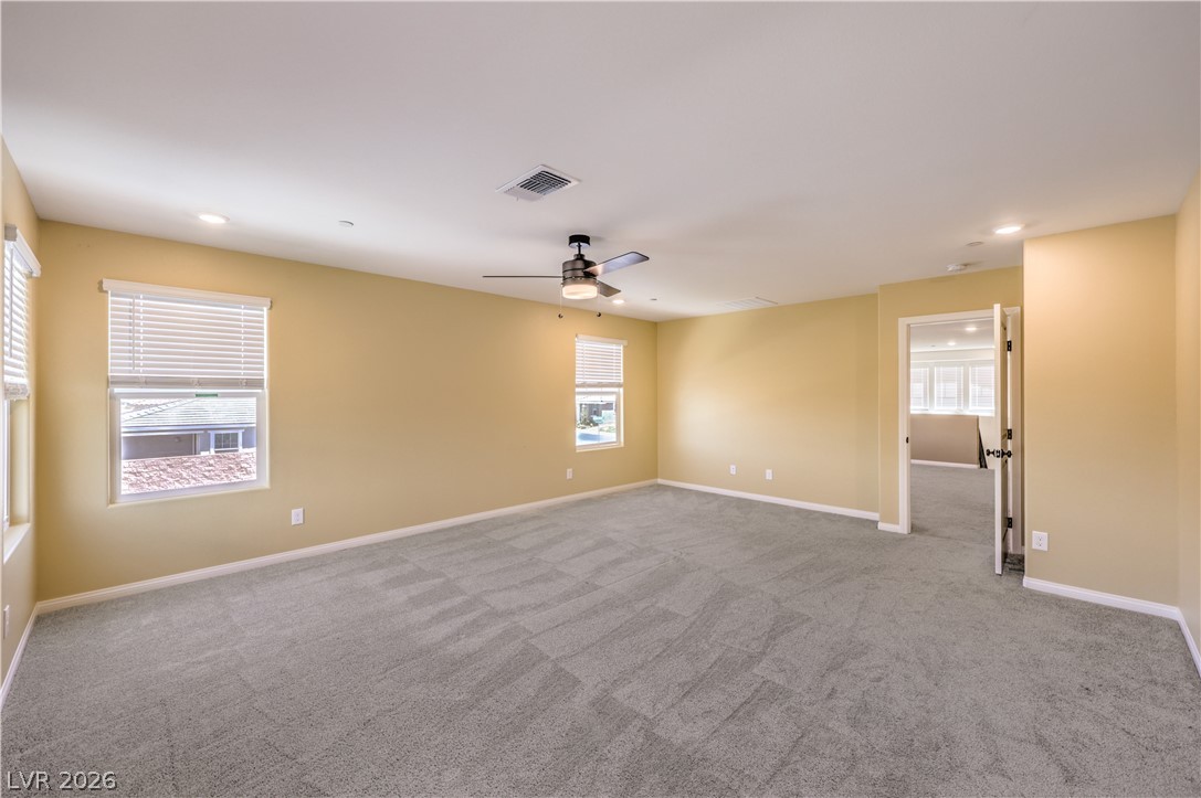 3782 Alla Rocca Avenue Henderson, NV 89044 - Photo 22 of 55 This spacious room features ample natural light and plush carpeting, creating a comfortable and inviting atmosphere.