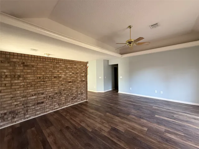 a view of a hallway with wooden floor and closet