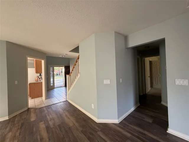 a view of a room with a ceiling fan and a window