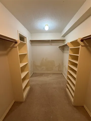 a spacious bathroom with a granite countertop sink mirror and shower
