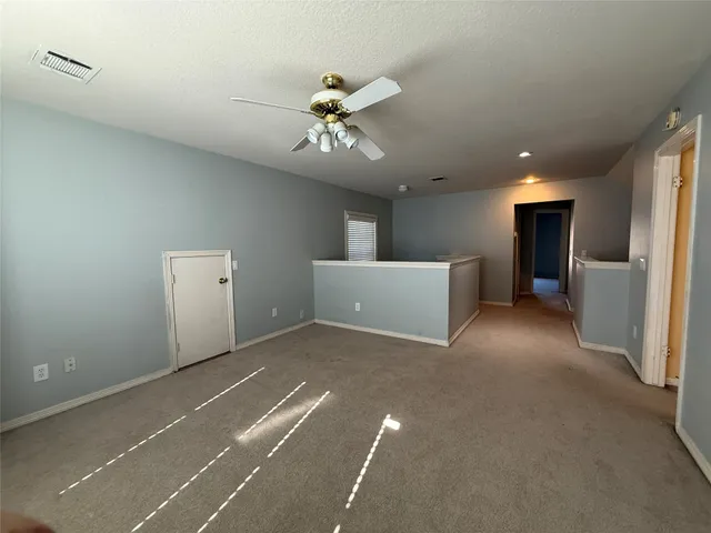 a view of a kitchen with a sink and a ceiling fan