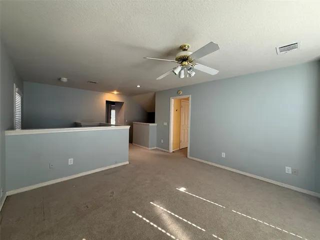 a view of kitchen with refrigerator and window