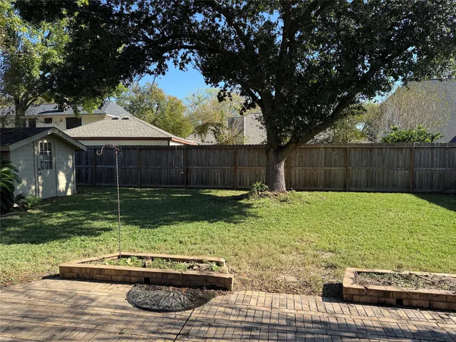 a front view of house with yard and trees around