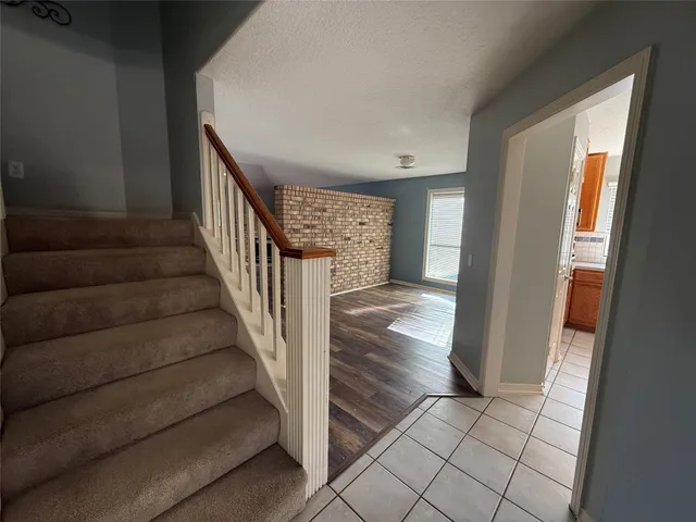 a kitchen with stainless steel appliances granite countertop a stove a refrigerator a sink a counter space and cabinets