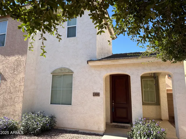a front view of a house with plants