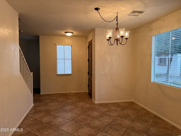 a view of a livingroom with a chandelier furniture and windows