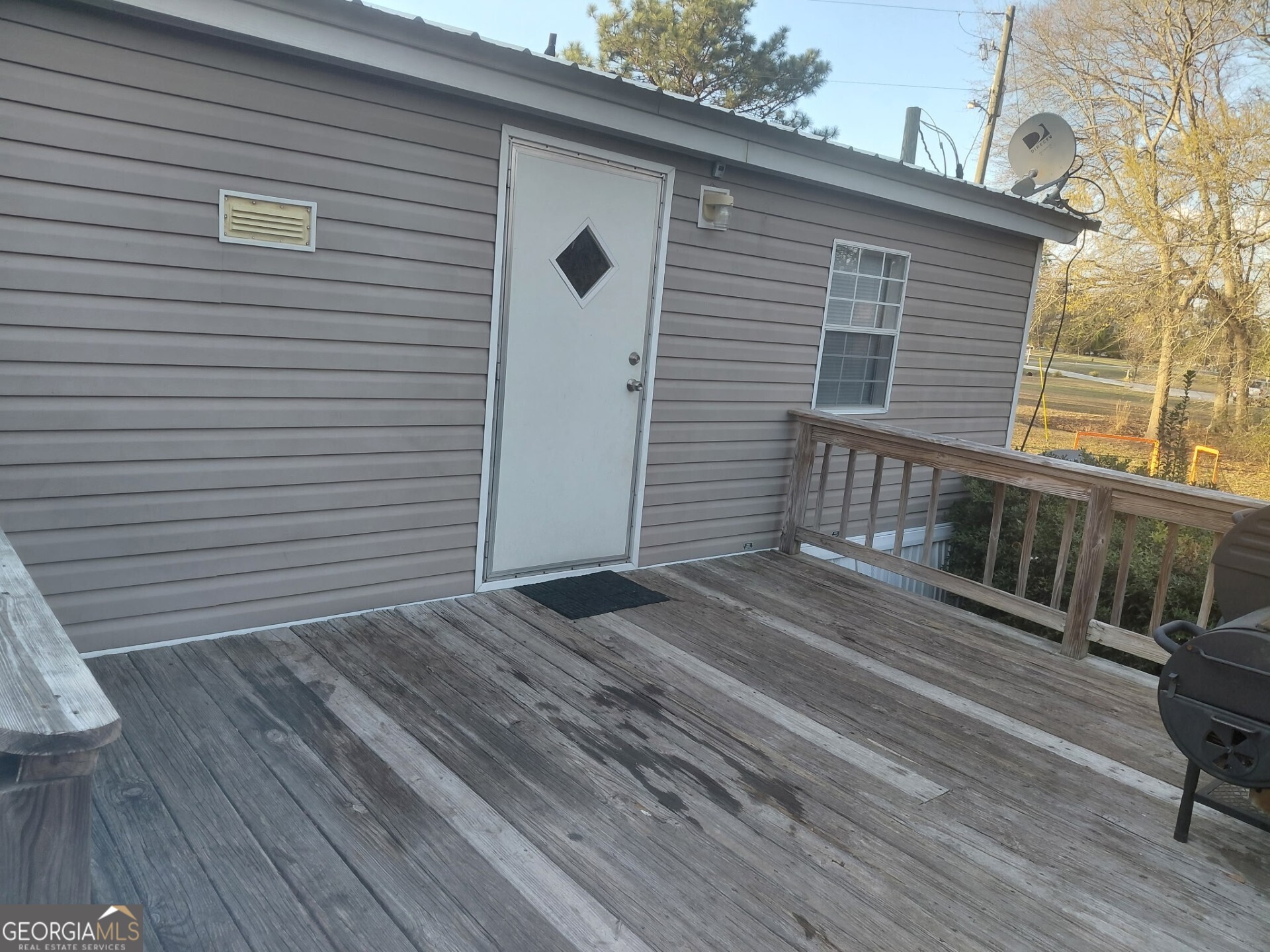 437 Burkhalter Circle Claxton, GA 30417 - Photo 3 of 8 a view of a house with a deck