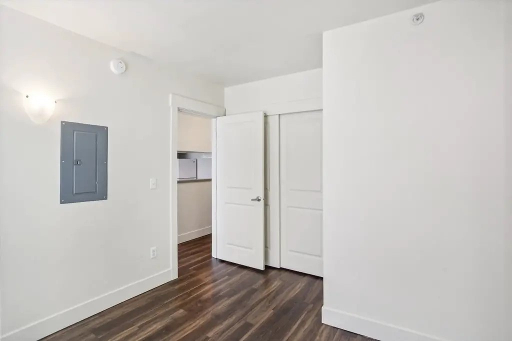 201 Yesler Way Seattle, WA 98104 - Photo 16 of 21 a view of an empty room with wooden floor