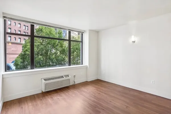 wooden floor in an empty room with a window