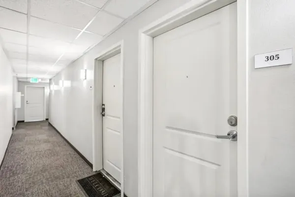 a bathroom with a toilet a sink a mirror a shower a vanity and mirror