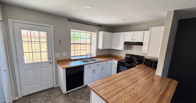 a kitchen with a sink stove and cabinets