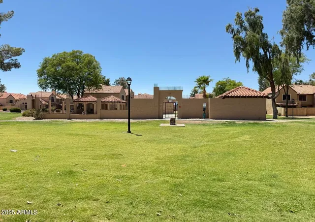 a house view with swimming pool in front of it