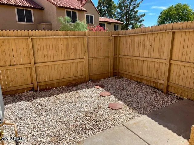 a backyard of a house with wooden fence