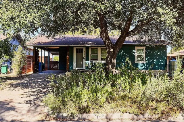 front view of a house with a tree