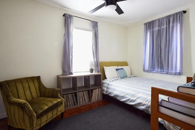 a bedroom with a bed and window