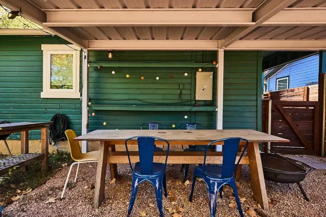 a table and chairs in front of a house