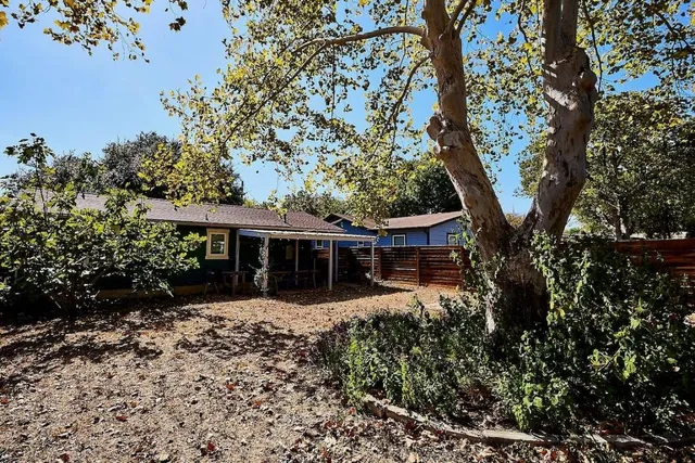 front view of a house with a tree