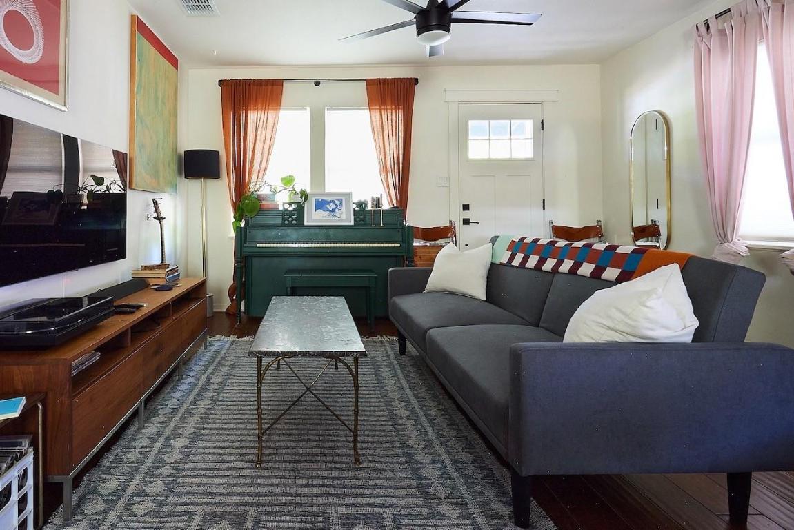 4704 Bandera Road Austin, TX 78721 - Photo 3 of 18 a living room with furniture and a flat screen tv