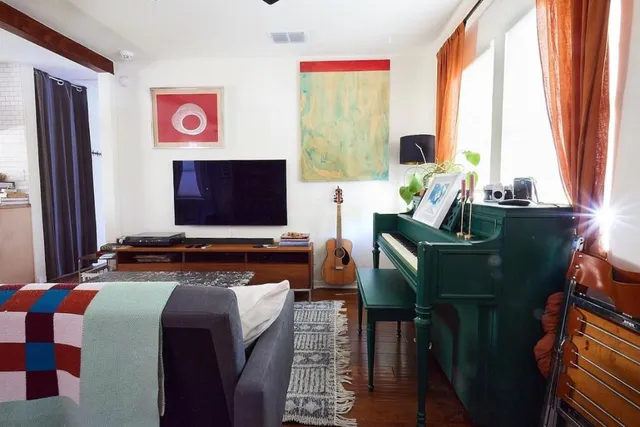 a living room with furniture and a flat screen tv