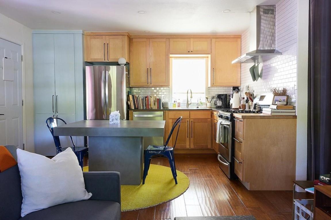 4704 Bandera Road Austin, TX 78721 - Photo 5 of 18 a dining room with furniture a large window and wooden floor