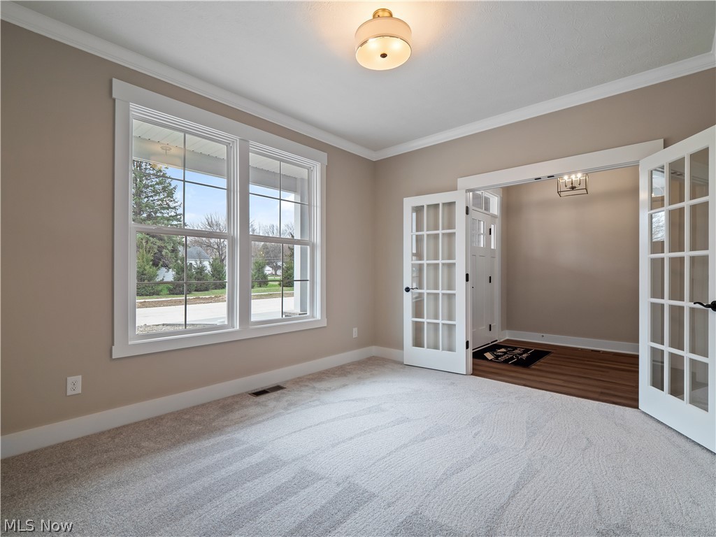 34270 Brookside Lane North Ridgeville, OH 44039 - Photo 10 of 50 Empty room with ornamental molding, french doors, and carpet flooring